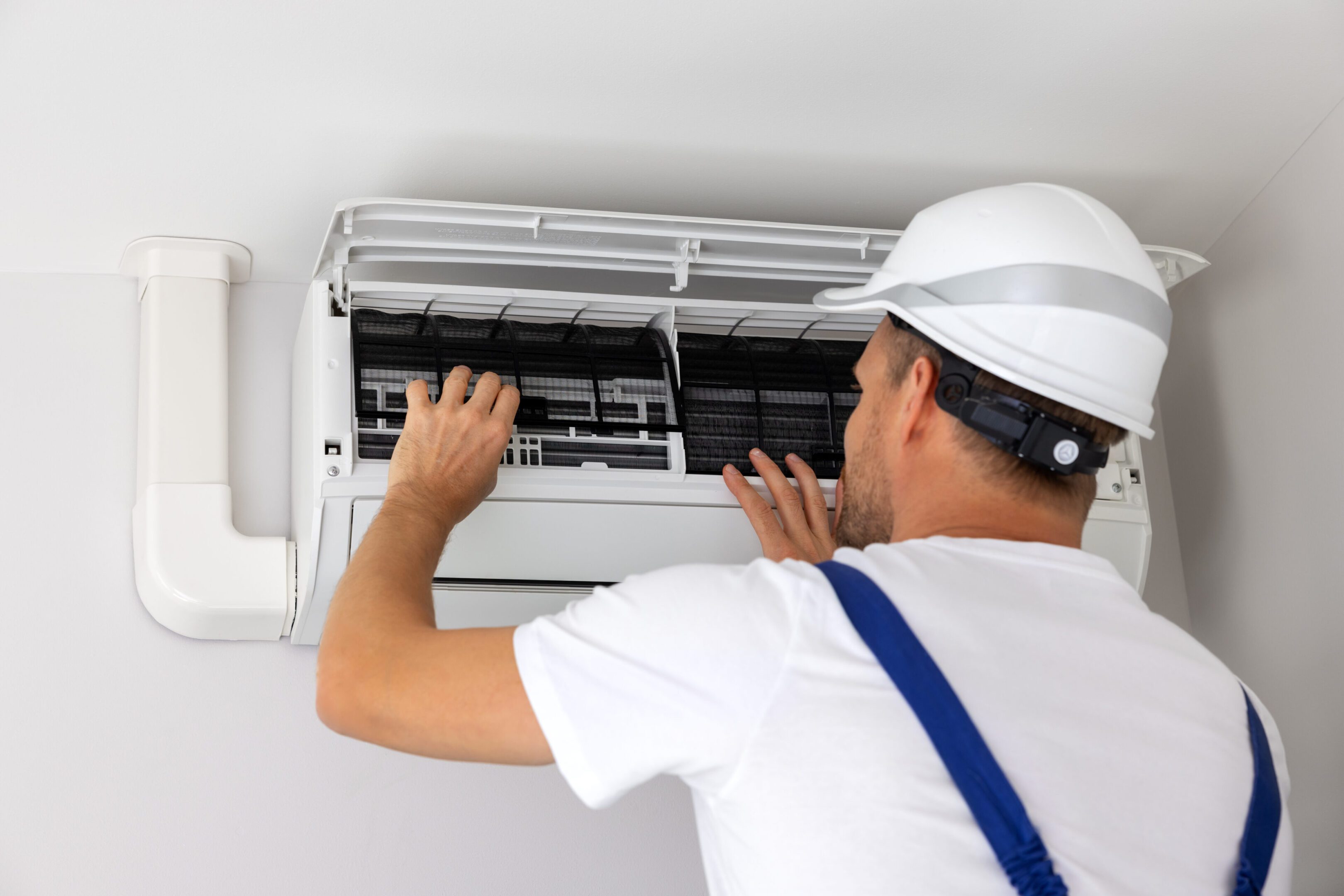 Technician inspecting air conditioning unit.
