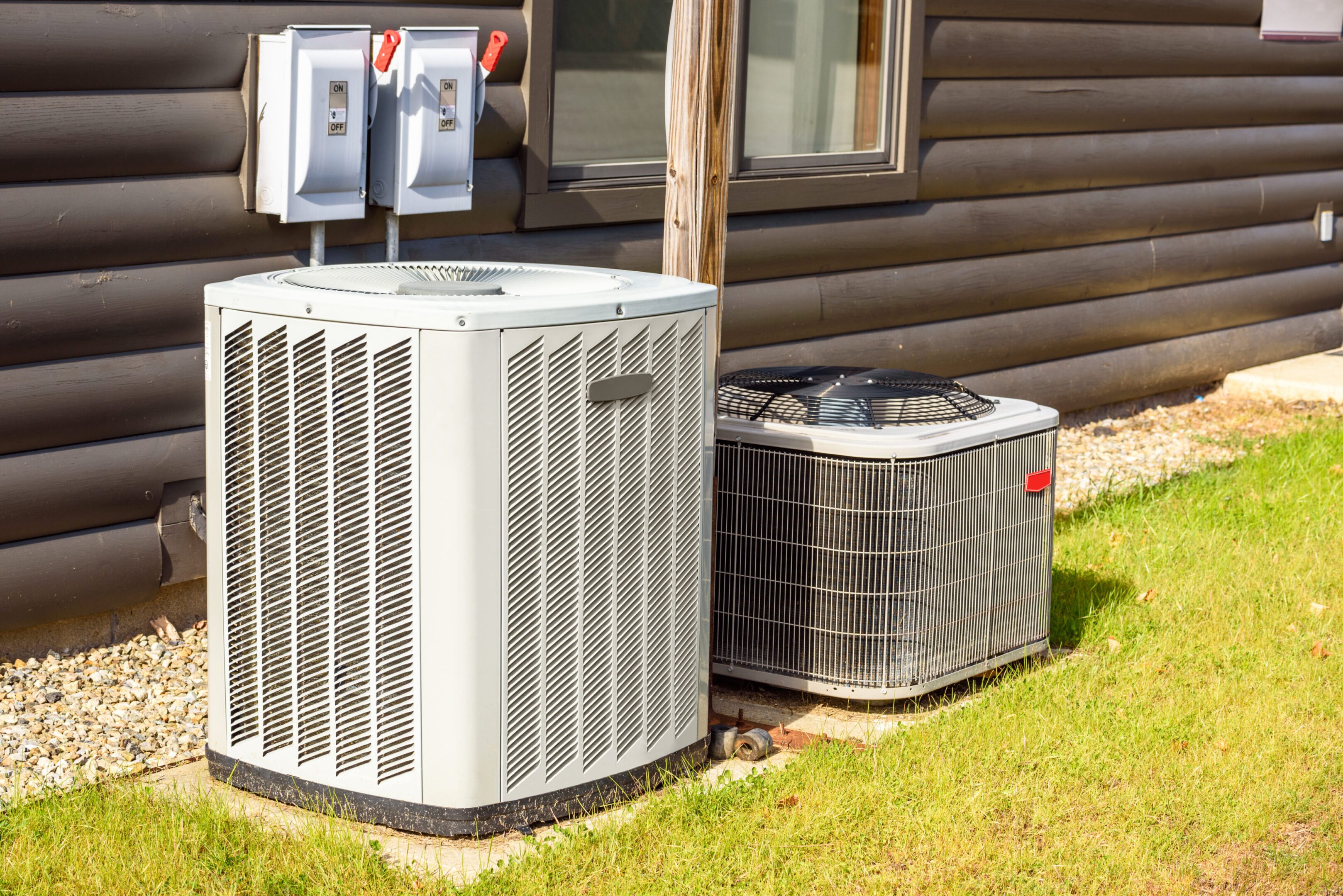 Air conditioning units outside a wooden house.