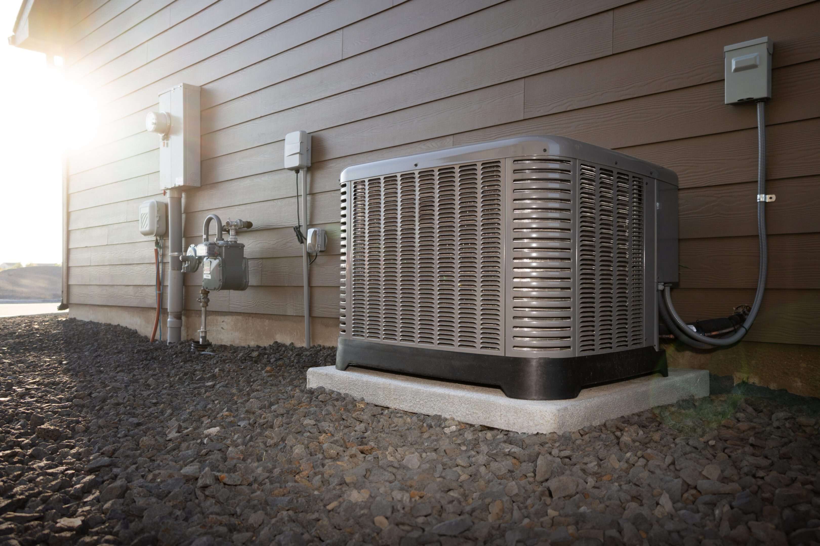 Outdoor air conditioning unit beside a house.